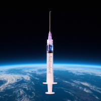 A syringe filled with liquid is suspended in front of a view of Earth from space, with the planet’s surface and atmosphere visible below.