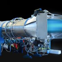 A jet engine undergoing a test, emitting a blue flame, with various wires and components attached.