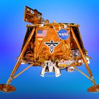 Gold lunar lander model with NASA and flag decals on a blue gradient background.