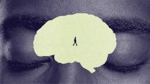 A person walks inside a large, light-colored brain shape superimposed over a close-up of a face with closed eyes.