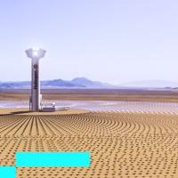 A solar tower in the middle of a desert.