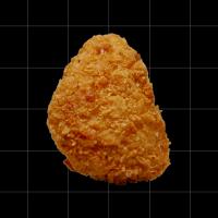 A piece of lab-grown fried chicken on a black background.
