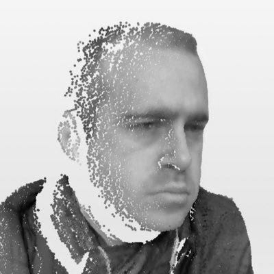A grayscale digital rendering of a man's face and upper body, created with a pointillist or dot-based technique against a plain background.